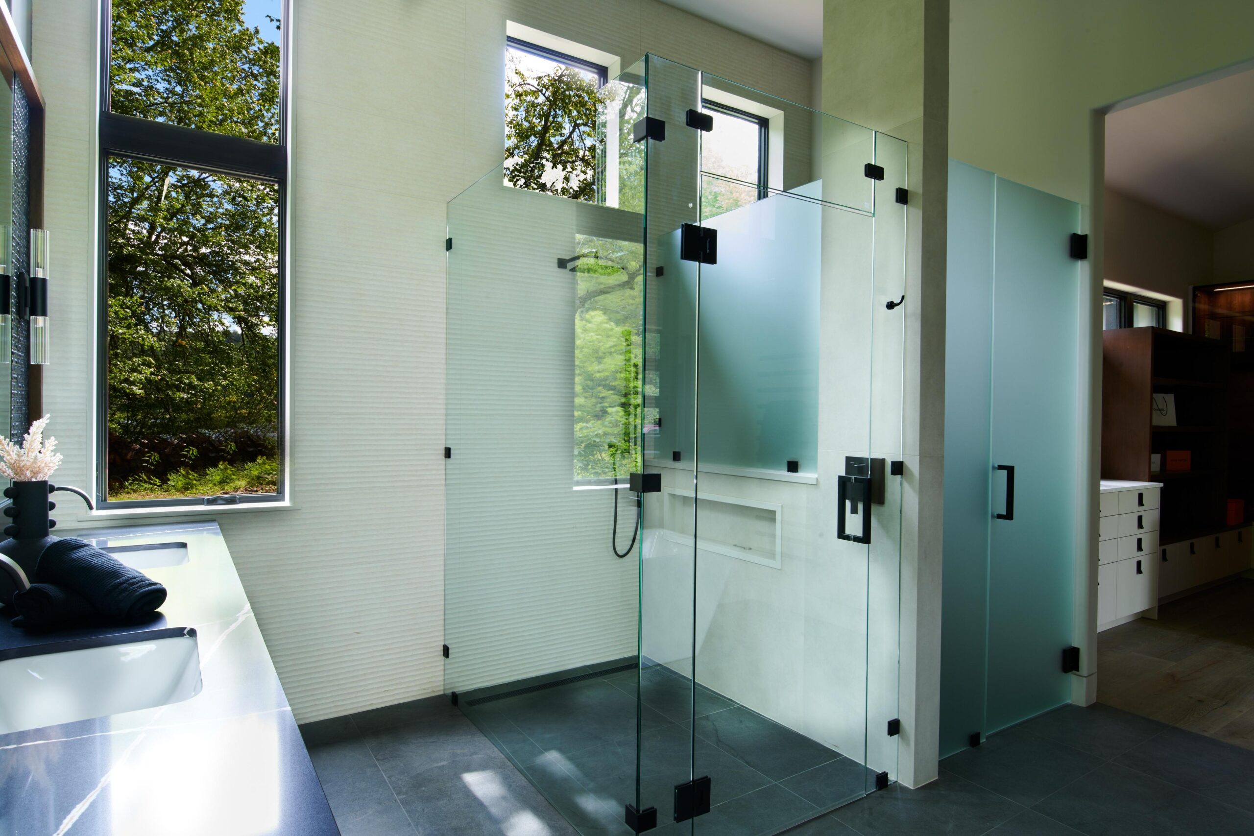 a_bathroom_with_a_glass_shower_and_a_sink_brdb_highlands_nc_master_bathroom_