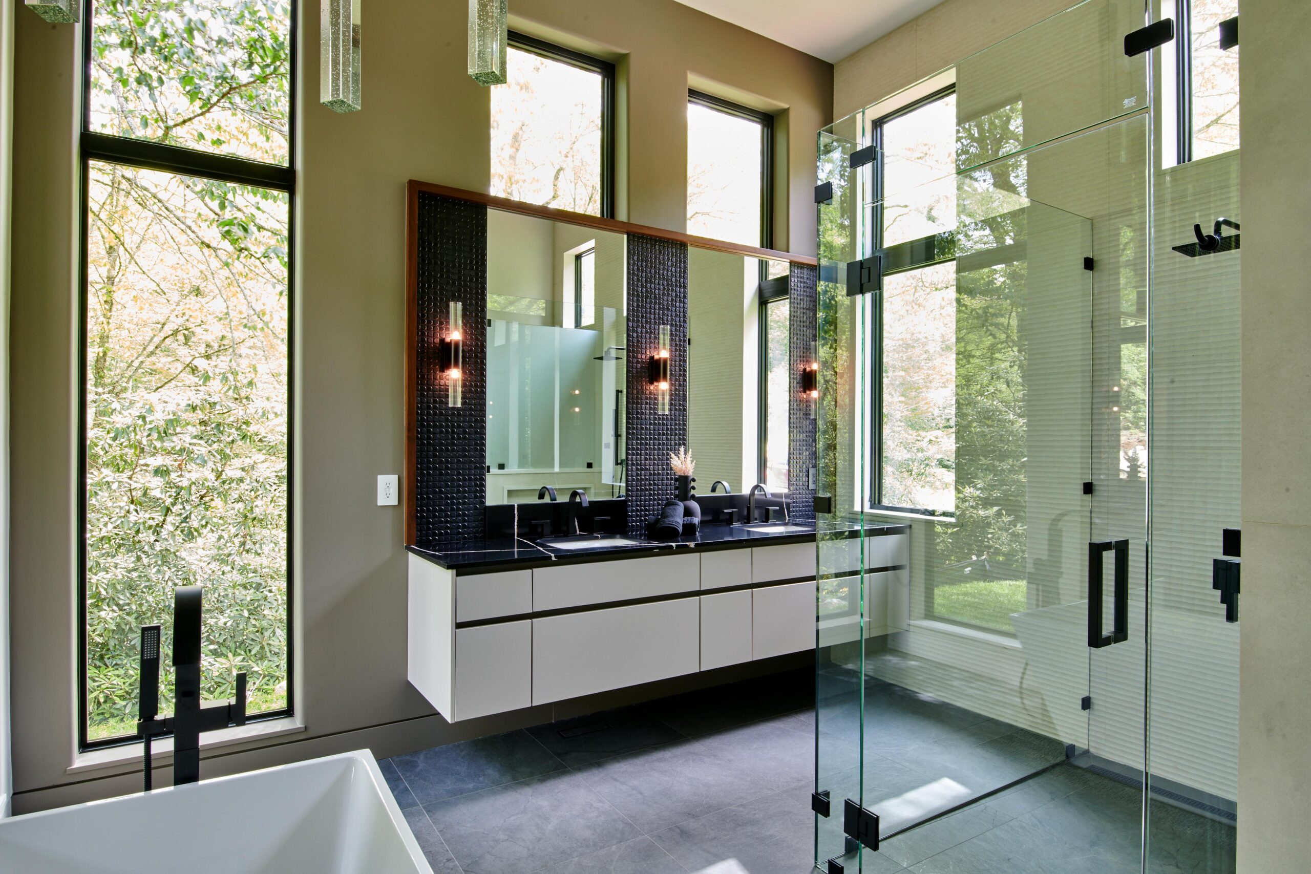 a_bathroom_with_a_large_tub_and_a_large_mirror_brdb_highlands_nc_master_bathroom_