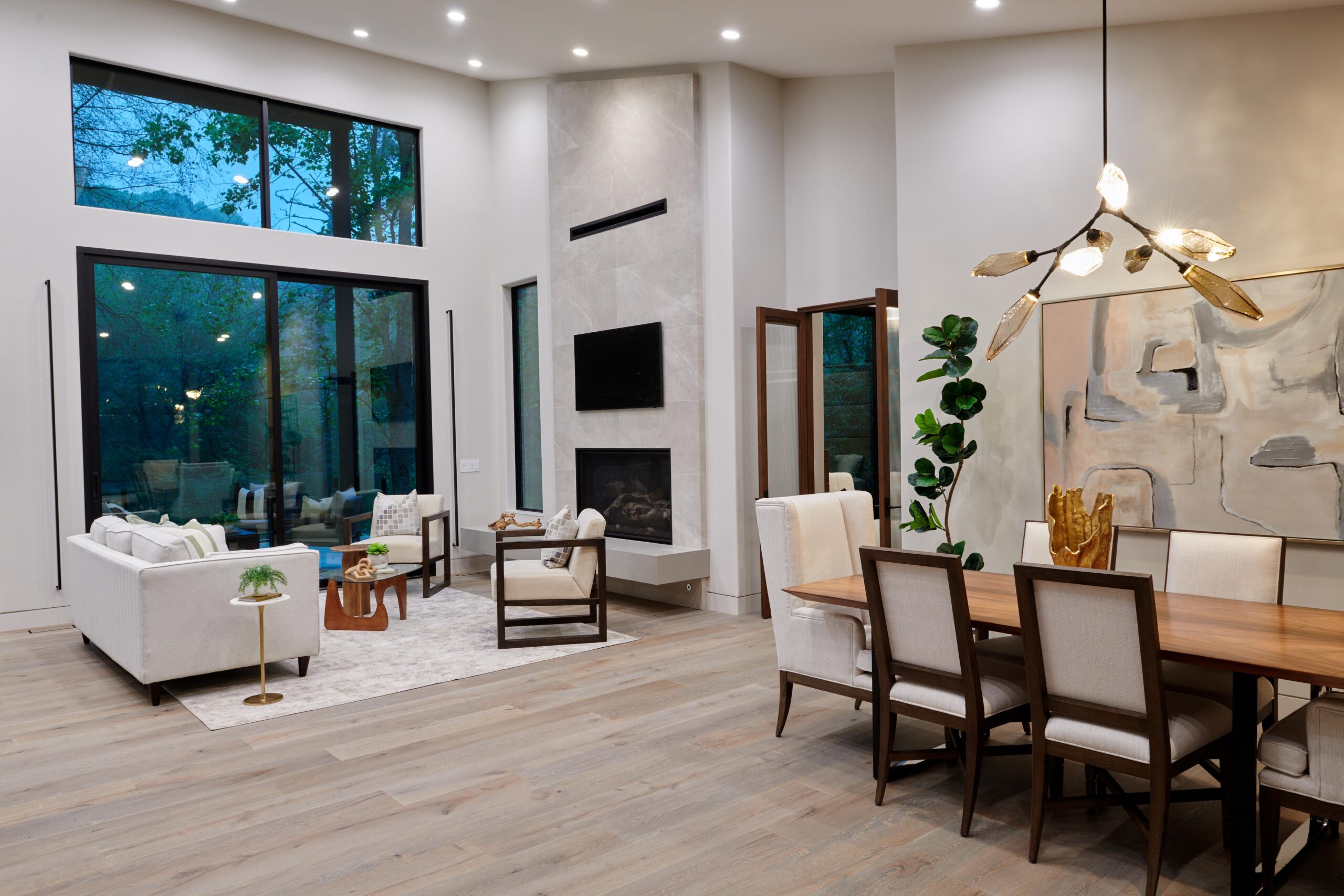 a_dining_room_with_a_large_window_and_a_large_painting_brdb_highlands_nc_living_room_