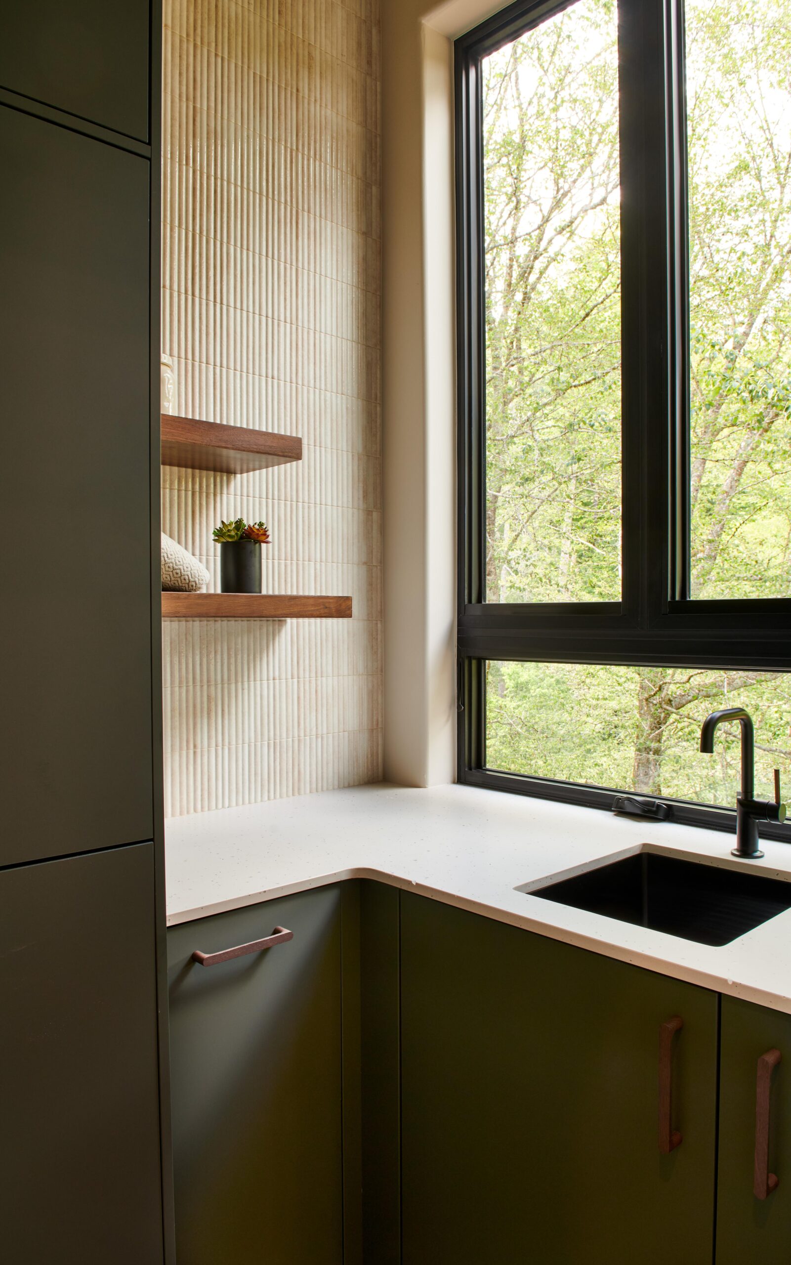 a_kitchen_with_a_sink_and_a_window_brdb_highlands_nc_laundry_natural_light