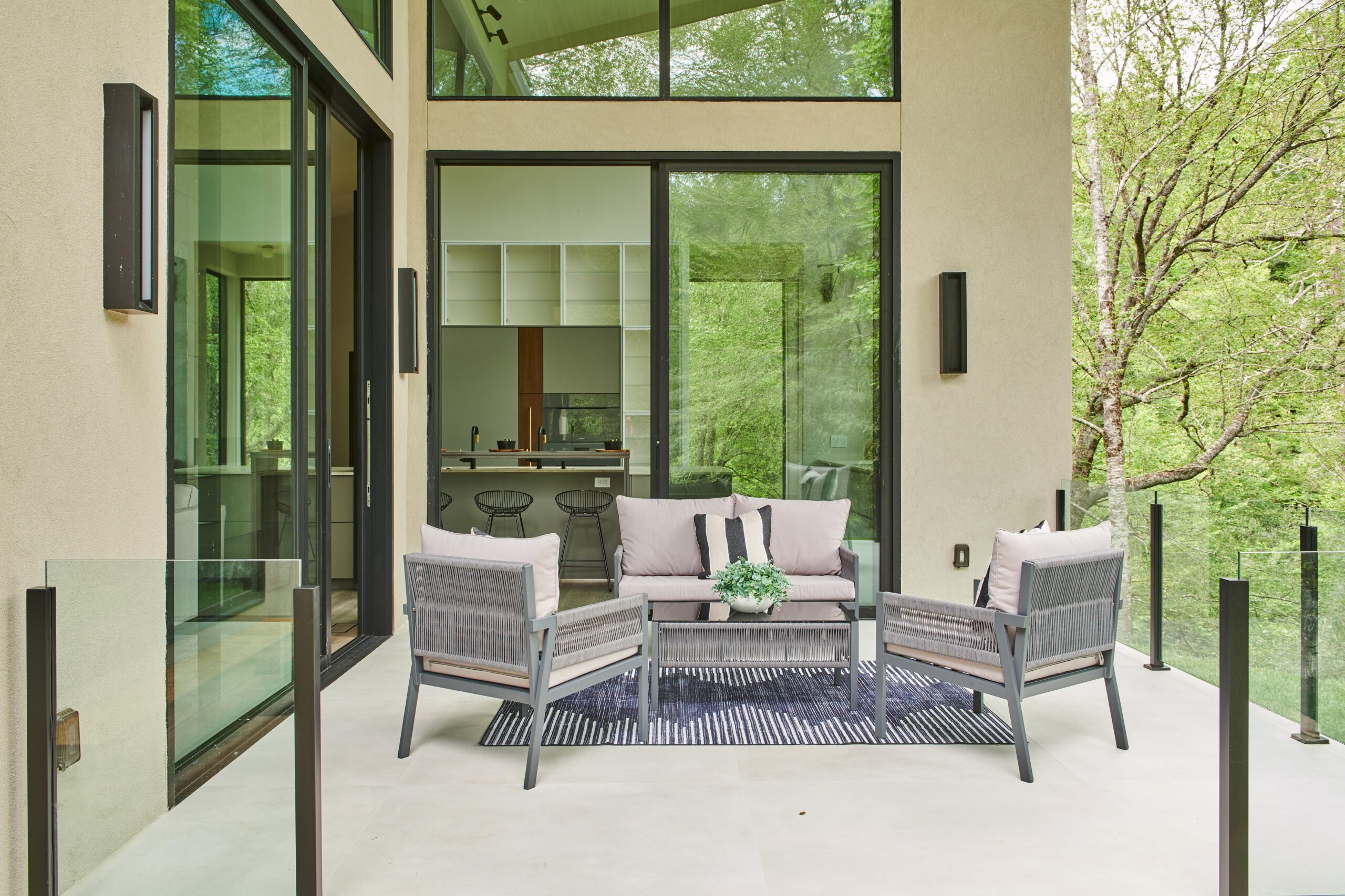 a_patio_with_a_couch_and_chairs_and_a_table_brdb_highlands_nc_porch_natural_light