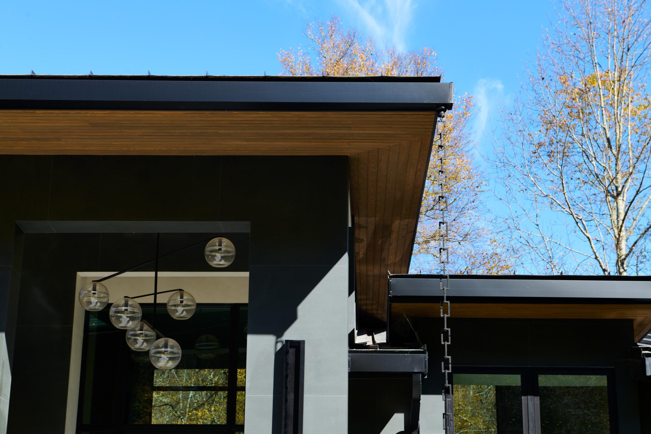 a_modern_house_with_a_wood_roof_and_metal_railing_brdb_highlands_nc_exterior-details_natural_light